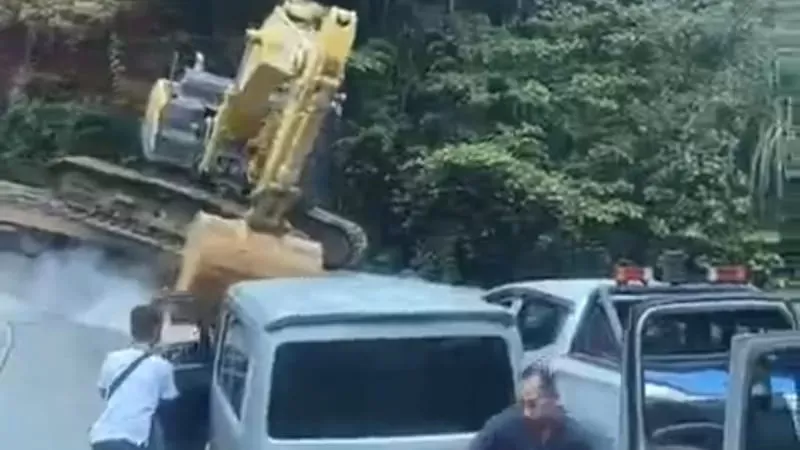 Ekskavator lepas dari truk trailer di Sitinjau Lauik, Rabu (4/2/2026), nyaris menghantam kendaraan lain dan membuat arus Padang–Solok padat. (Foto: Tangkap Layar Video)
