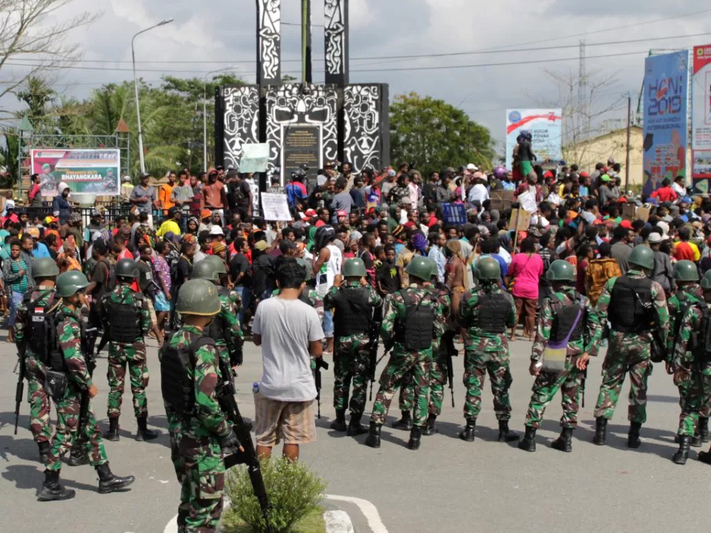 Warga melakukan aksi dengan pengawalan prajurut TNI di Bundaran Timika Indah, Mimika, Papua, Rabu (21/8/2019)/ANTARA/Jeremias Rahadat.