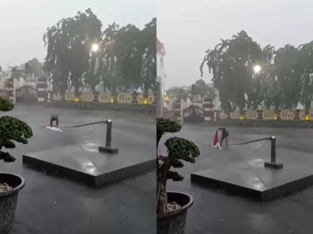 Pria yang menyelamatkan bendera Merah Putih di tengah derasnya hujan (Screenshot/Facebook/Yudha Agung)