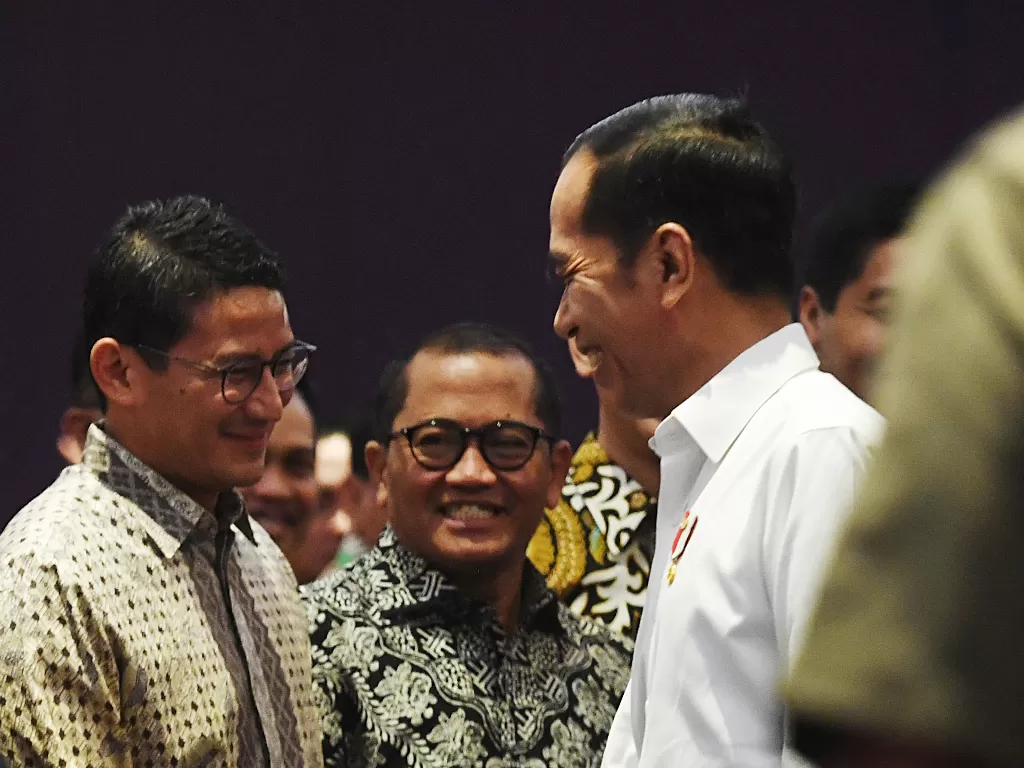Presiden Joko Widodo (kanan) berbincang dengan Sandiaga Uno (kiri) di sela-sela pelantikan Badan Pengurus Pusat Himpunan Pengusaha Muda Indonesia (BPP HIPMI) periode 2019-2022 di Jakarta, Rabu (15/1/2020). (ANTARA FOTO/Akbar Nugroho Gumay)
