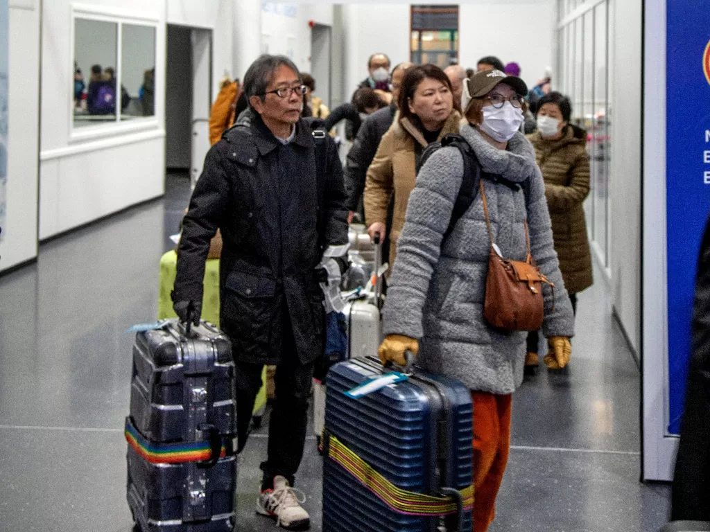 Warga Tiongkok mengenakan masker untuk cegah penyebaran virus korona. (REUTERS/Lehtikuva/Tarmo Lehtosalo)