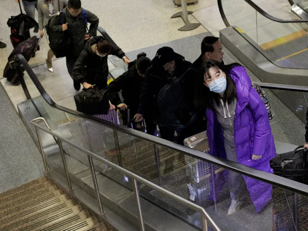 Warga Tiongkok mengenakan masker untuk cegah penyebaran virus korona (REUTERS/David Ryder)
