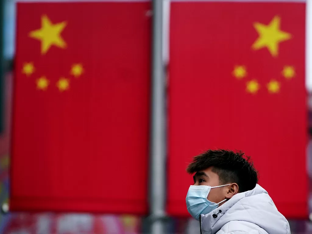 Seorang pria mengenakan masker di Shanghai, Tiongkok, untuk mencegah tertular virus korona (REUTERS/Aly Song).