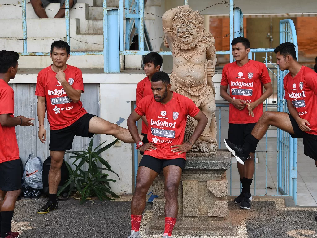 Pesepak bola Bali United melakukan peregangan otot saat latihan ketahanan fisik di GOR Ngurah Rai menjelang kompetisi Piala AFC, Denpasar, Bali, Rabu (8/1).  (ANTARA FOTO/Nyoman Budhiana)