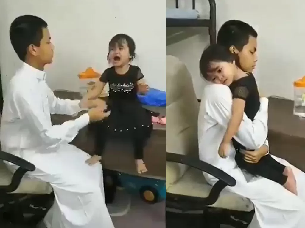 Tangkapan layar dari video seorang bocah yang berhenti menangis setelah dipeluk sang kakak. (photo/Twitter/@RomaanPicisan)