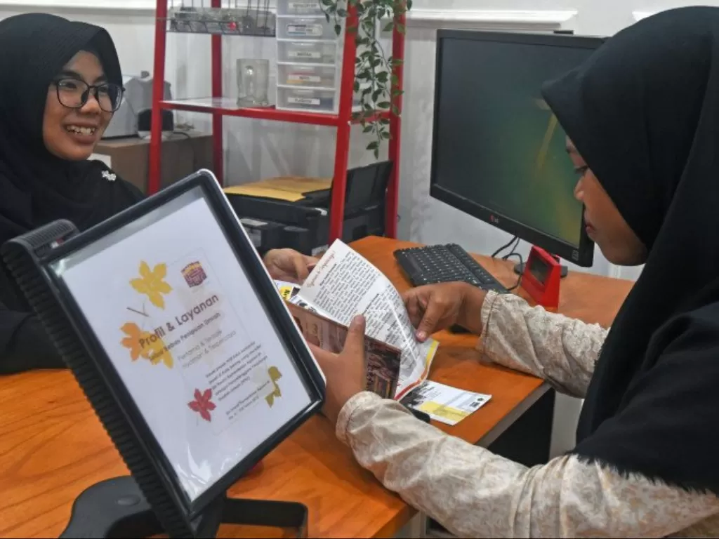 Ilustrasi - Petugas Agen Perjalanan Munir Imani melayani konsumen yang bertanya soal penghentian layanan ibadah Umrah oleh Pemerintah Arab Saudi, di Lontar, Serang, Banten, Kamis (27/2/2020).(Photo/ANTARA/Asep Fathulrahman)