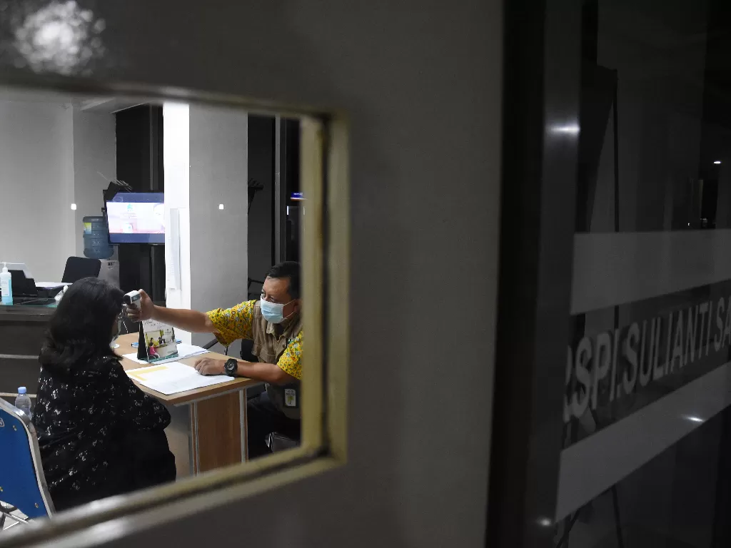 Dokter memeriksa suhu tubuh warga di Pos Pemantauan Virus Corona RSPI Sulianti Saroso, Jakarta Utara, Selasa (3/3/2020). (ANTARA FOTO/Indrianto Eko Suwarso)
