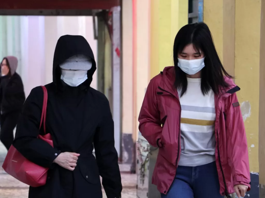 Ilustrasi:  dua wanita di Macau memakai masker untuk mencegah penularan virus corona. (Unsplash/Macau Photo Agency)
