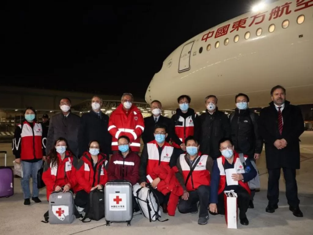 Tim medis dari China disambut tim Palang Merah Italia setibanya di Bandara Fiumicino, Roma, pada 12 Maret 2020. (Photo/ANTARA/HO-Xinhua/mii)