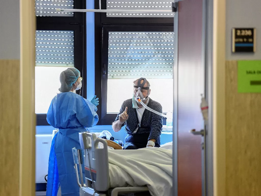 Staf medis saat memberikan arahan pada pasien corona. (REUTERS/Flavio Lo Scalzo)