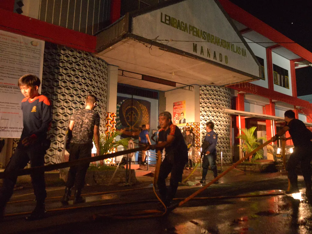 Anggota pemadam kebakaran berupaya memadamkan api yang membakar sejumlah ruangan saat terjadinya kerusuhan di Lembaga Pemasyarakatan (Lapas) Kelas IIA Manado, Tuminting, Manado, Sulawesi Utara, Sabtu (11/4/2020).  (Photo/ANTARA FOTO/Adwit B Pramono)