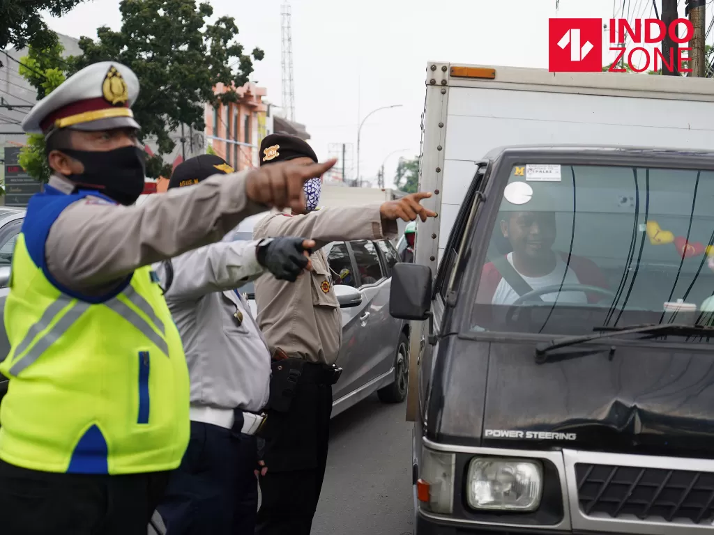 Petugas menghimbau pengguna kendaraan bermotor saat melakukan Pengawasan Pelaksanaan PSBB di Jalan Ciledug Raya, Jakarta. (INDOZONE/Arya Manggala)