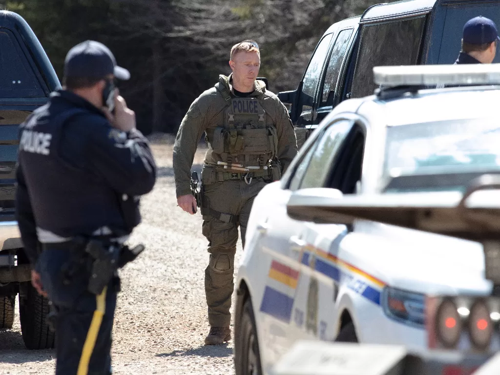 Petugas RCMP mempertahankan blok jalan setelah membawa Wortman ke tahanan di Portapique. (REUTERS/John Morris)