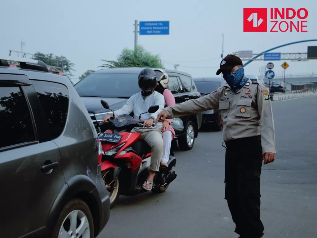 Petugas menghimbau pengguna kendaraan bermotor saat melakukan Pengawasan Pelaksanaan PSBB. (INDOZONE/Febio Hernanto)