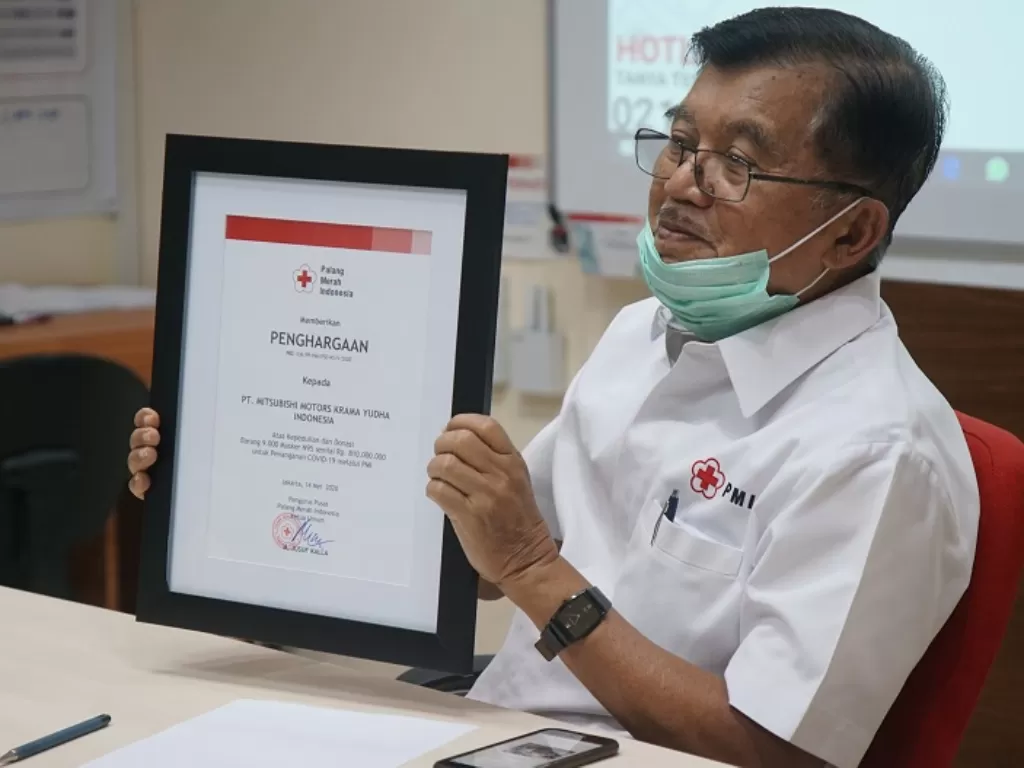 Ketua Umum Palang Merah Indonesia, Jusuf Kalla. memegang Piaga penghargaan untuk donasi MMKI. (Dok. Mitsubishi)