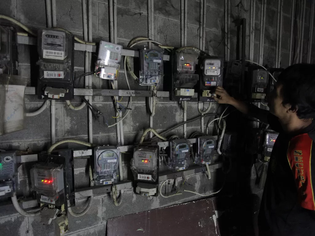 Ilustrasi warga memeriksa meteran listrik. (ANTARA/Reno Esnir)