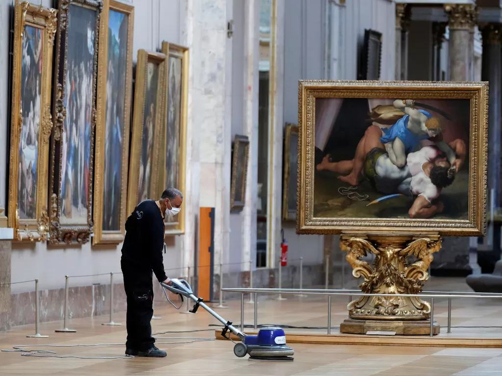   Seorang pekerja memoles lantai galeri museum Louvre di Paris saat bersiap untuk dibuka kembali di Prancis, 23 Juni 2020. (REUTERS/Charles Platiau)