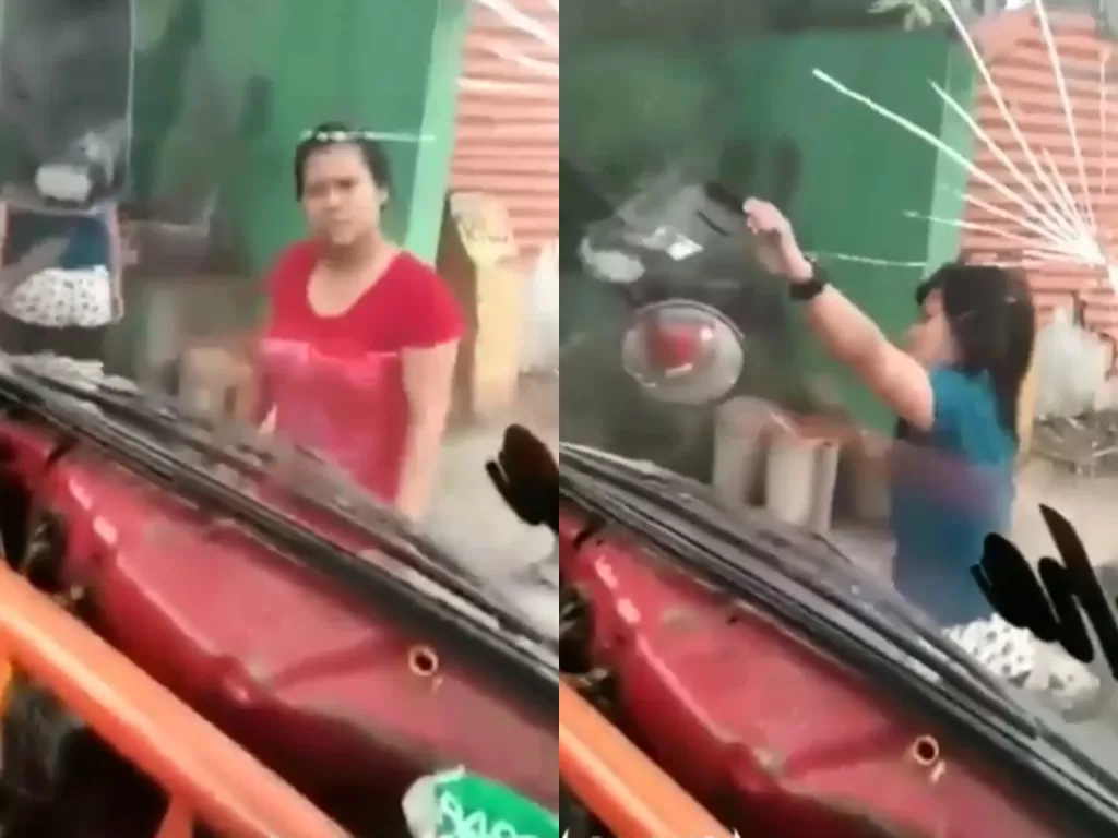 Dua perempuan memecahkan kaca truk usai meminta paksa uang parkir kepada sopir. (Foto: Istimewa)