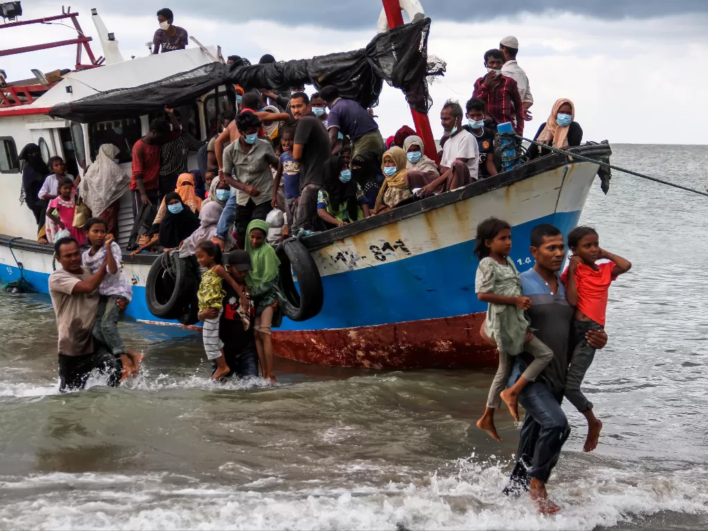 Warga melakukan evakuasi paksa pengungsi etnis Rohingya dari kapal di pesisir pantai Lancok, Kecamatan Syantalira Bayu, Aceh Utara, Aceh, Kamis (25/6/2020). (Photo/ANTARA FOTO/Rahmad)