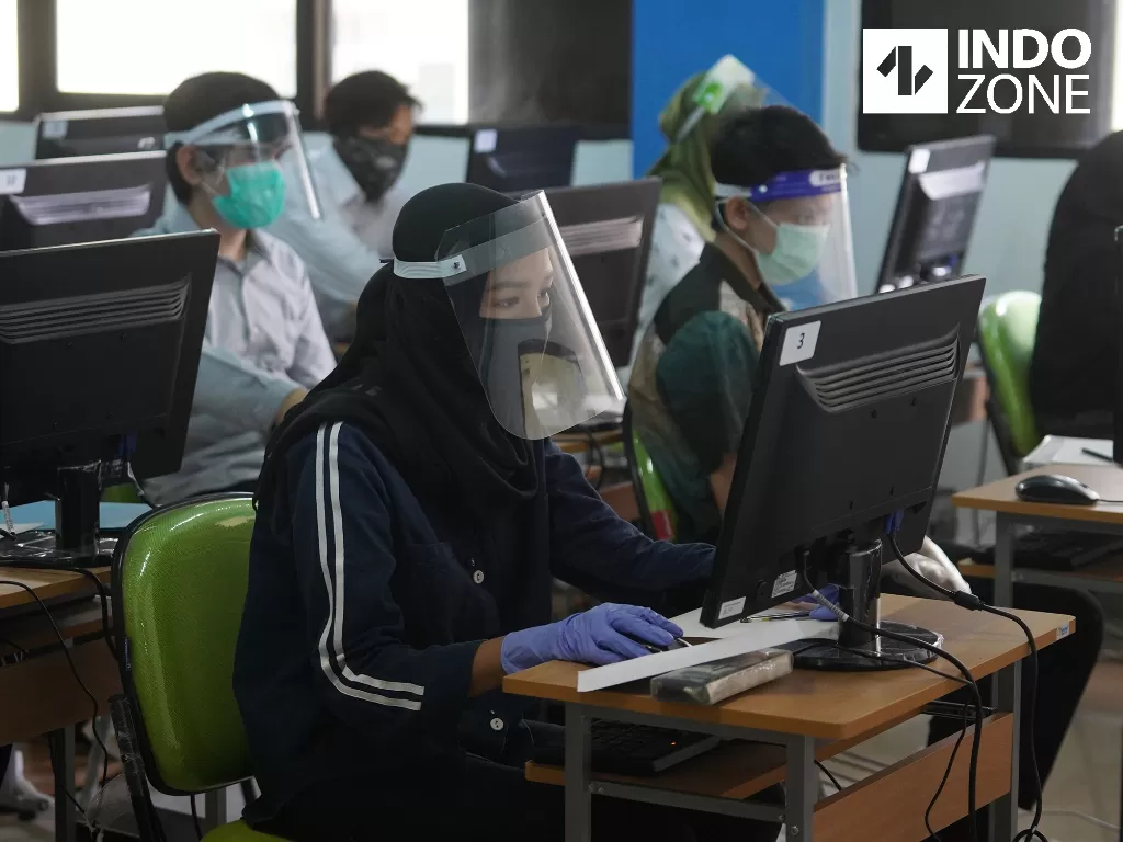 Peserta mengikuti Ujian Tulis Berbasis Komputer Seleksi Bersama Masuk Perguruan Tinggi Negeri (UTBK-SBMPTN) di Universitas Negeri Jakarta, Minggu (5/7/2020). (INDOZONE/Arya Manggala)