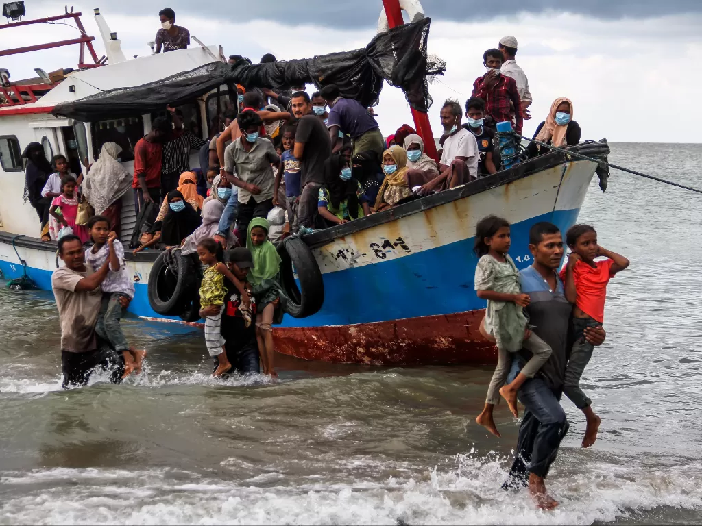 Warga melakukan evakuasi paksa pengungsi etnis Rohingya dari kapal di pesisir pantai Lancok, Kecamatan Syantalira Bayu, Aceh Utara, Aceh, Kamis (25/6/2020). (Photo/ANTARA FOTO/Rahmad)