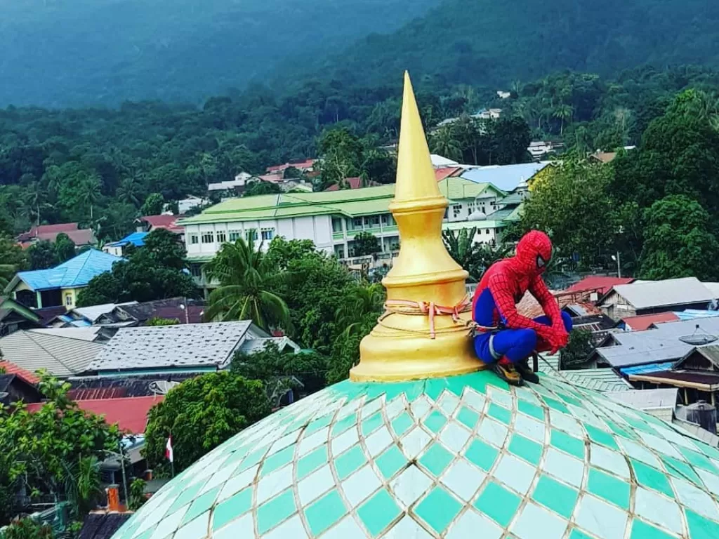 Sosok 'spiderman' di puncak kubah masjid. (Instagram/@disparpora.kotabaru)