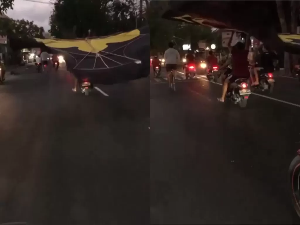 Potongan video pengendara yang nekat membawa layangan gunakan sepeda motor. (photo/Instagram/ denpasar.viral)