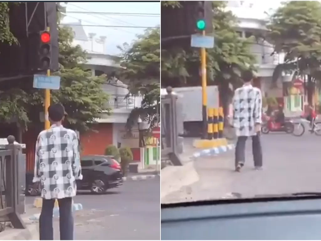 Pria pejalan kaki tunggu lampu merah berubah hijau untuk meneruskan langkahnya. (Twitter @closetowhy)