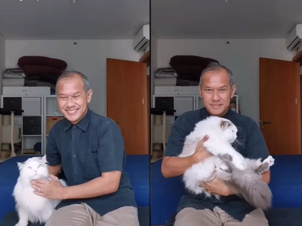 Cuplikan video saat pria yang membagikan tips cara menggendong kucing supaya nyaman. (photo/TikTok/@kucingomwepe)
