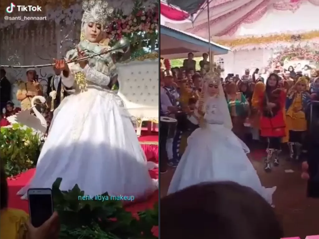 Cuplikan video disaat pengantin wanita yang menjadi mayoret di acara pernikahannya sendiri. (photo/TikTok/@santi_hennaart)