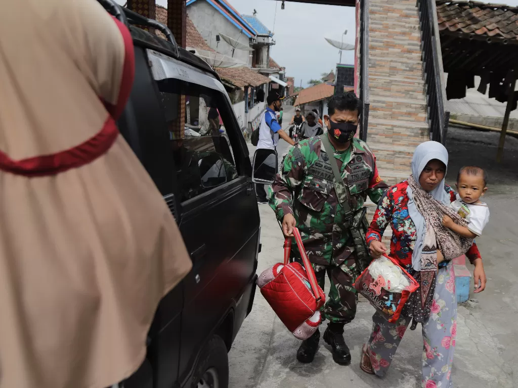 Personel TNI membantu warga menuju tempat pengungsian (ANTARA FOTO/Taufiq R)