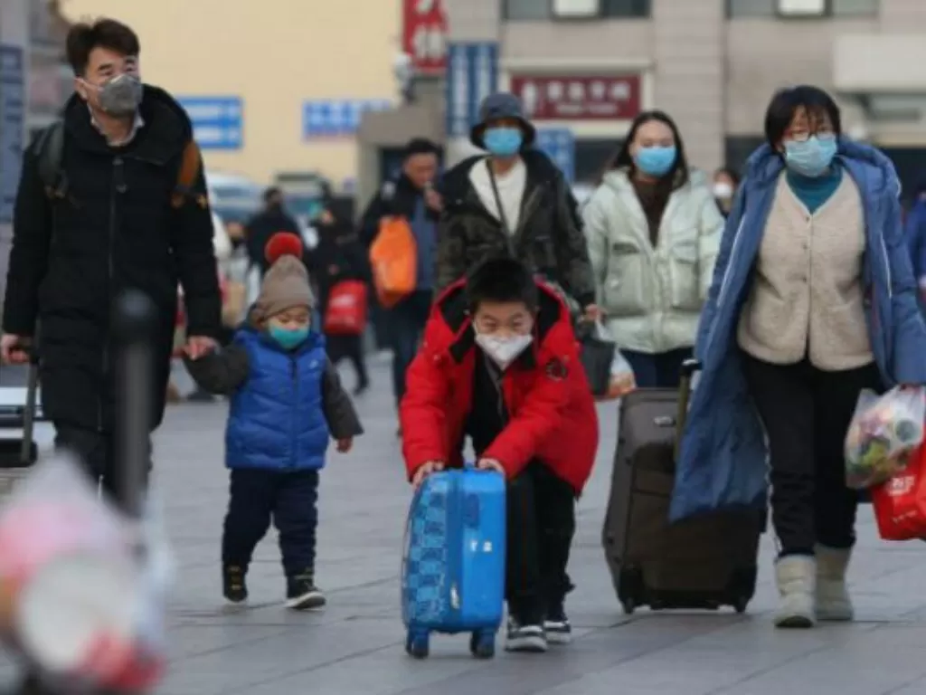 Warga mengenakan masker di stasiun kereta di Beijing, Tiongkok, Jumat (24/1/2020). (Yomiuri Shimbun via REUTERS)