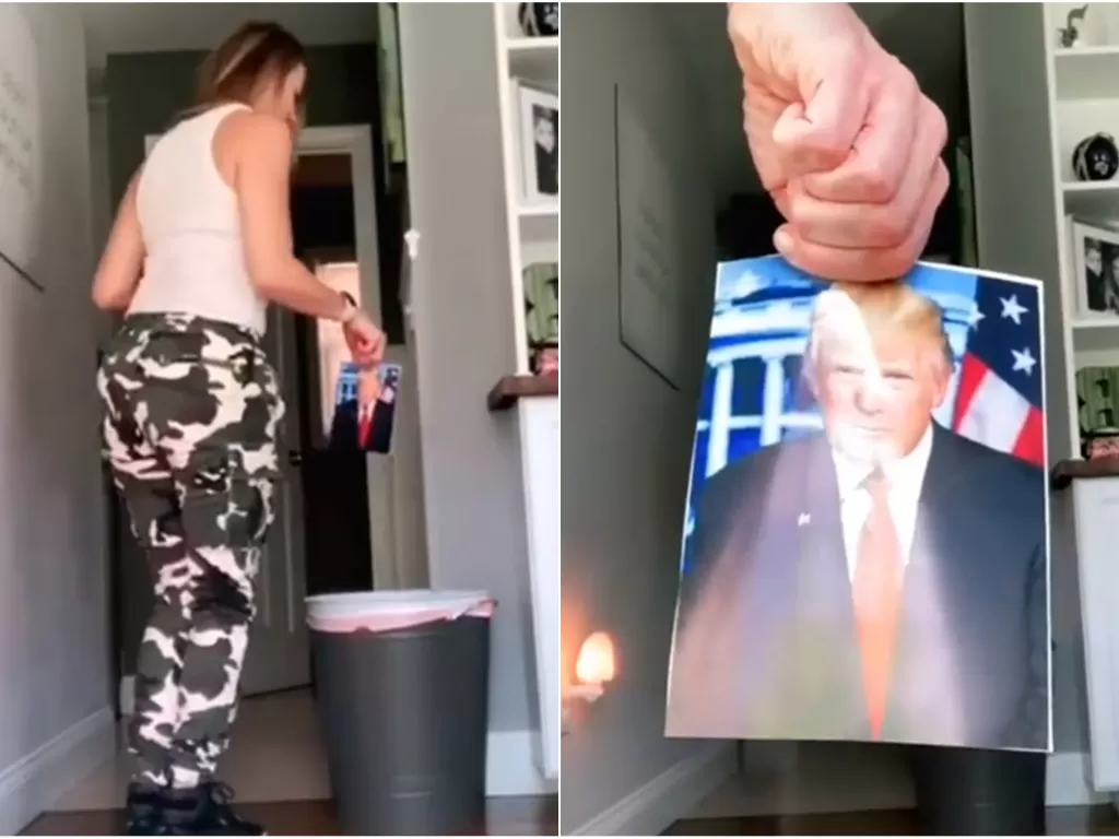 Seorang wanita warga AS membuang foto Donald Trump ke tong sampah. (Istimewa)