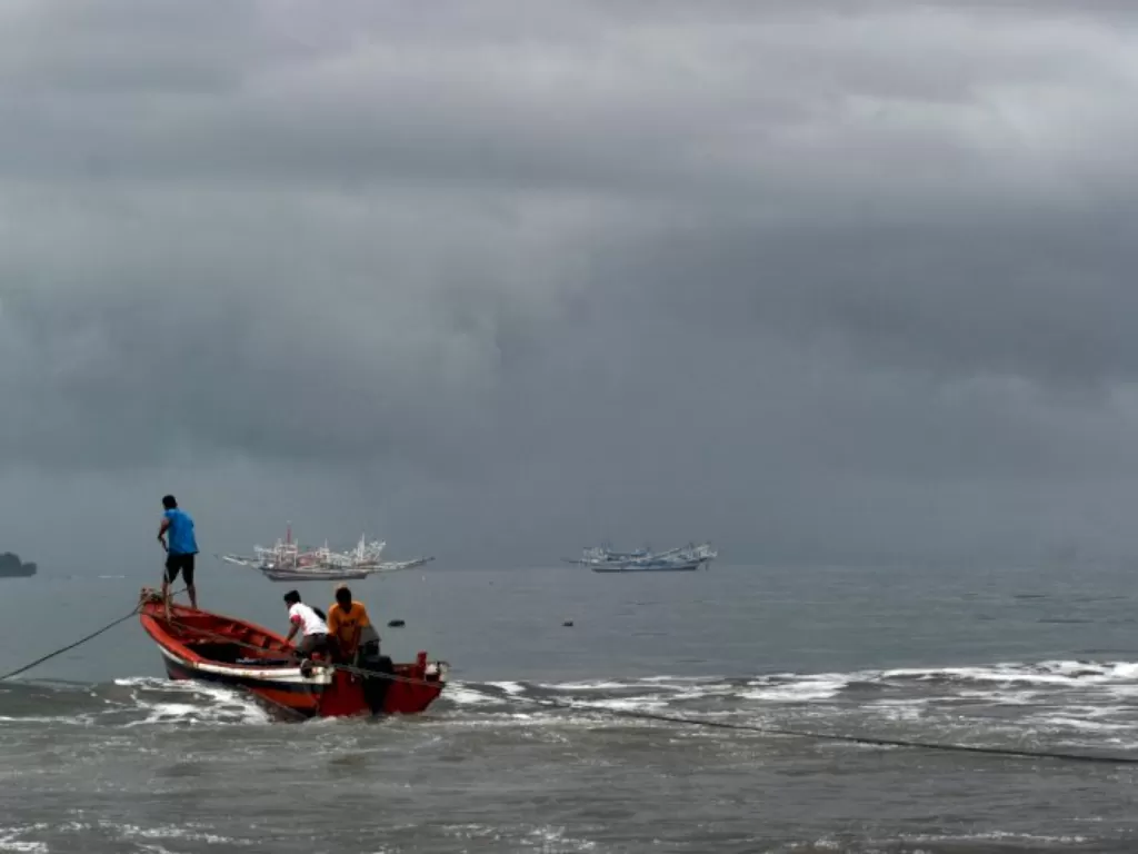 Nelayan memindahkan bahan bakar untuk kapal bagan saat langit berawan di Pantai Pasie Nan Tigo, Padang, Sumatera Barat, Senin (2/11/2020). (ANTARA FOTO/Iggoy el Fitra)