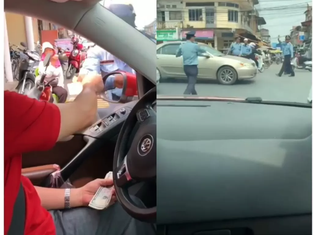 Cuplikan video saat oknum polisi lalu lintas yang diberi uang oleh pengemudi saat macet. (photo/Instagram/Instimewa)