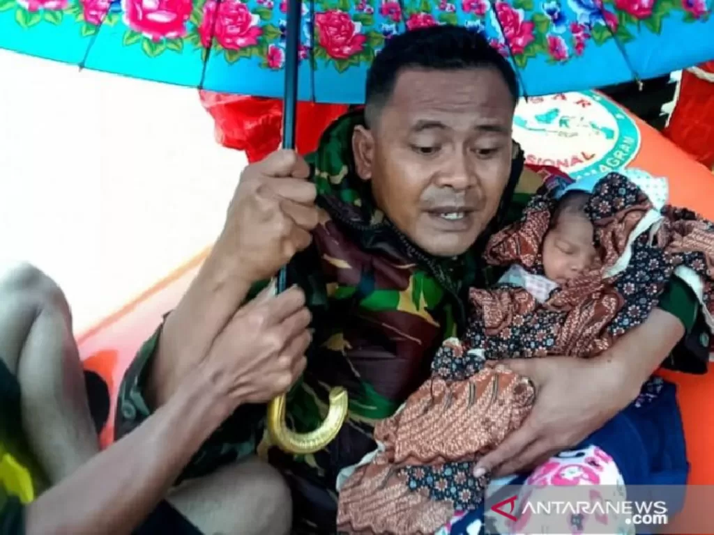 Prajurit TNI mengevakuasi bayi yang berumur empat hari yang terjebak banjir di Gampong Alue Bate Kecamatan Rantau Peureulak Kabupaten Aceh Timur, Sabtu (5/12/2020) (ANTARA/HO)