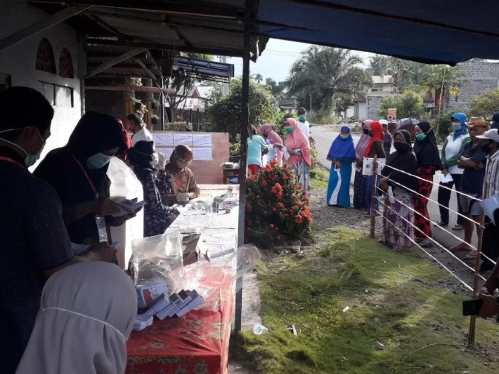 Petugas KPPS di TPS Bandarejo Kecamatan Pasaman Kabupaten Pasaman Barat saat mau memulai pencoblosan pada Rabu (9/12/2020) pagi. (Foto: Antara)