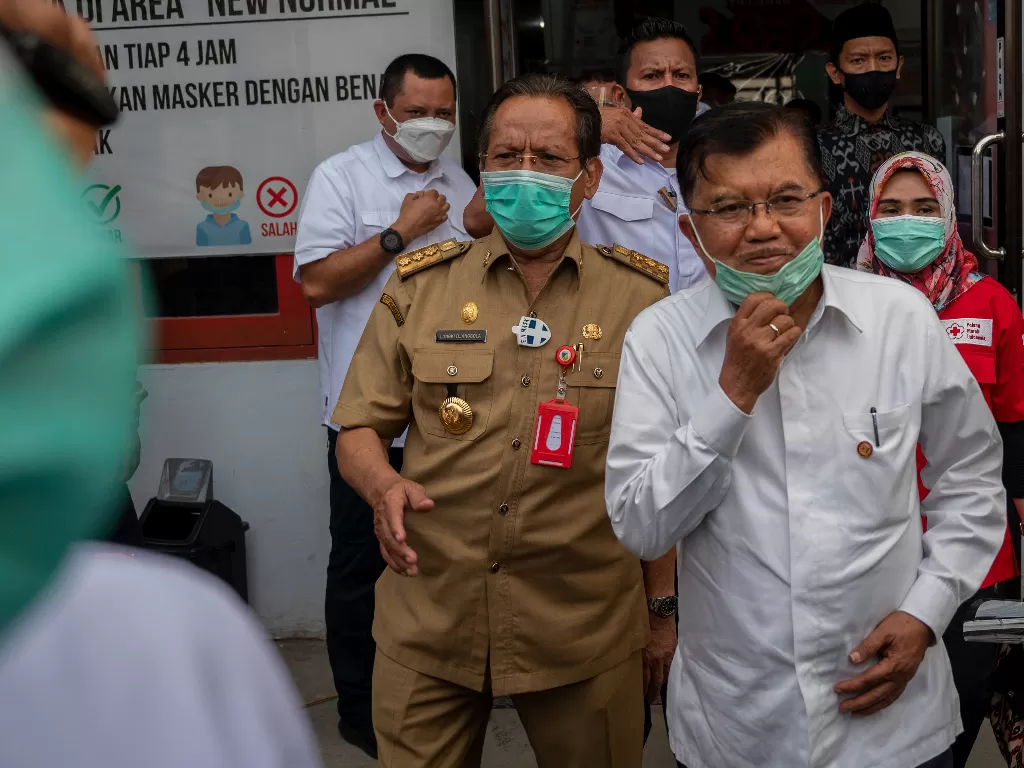 Ketua Umum Palang Merah Indonesia (PMI) Jusuf Kalla (kanan) bersama Gubernur Sulteng Longki Djanggola (kiri) berjalan meninggalkan gedung Unit Trasfusi Darah (UTD). ANTARA FOTO/Basri Marzuki