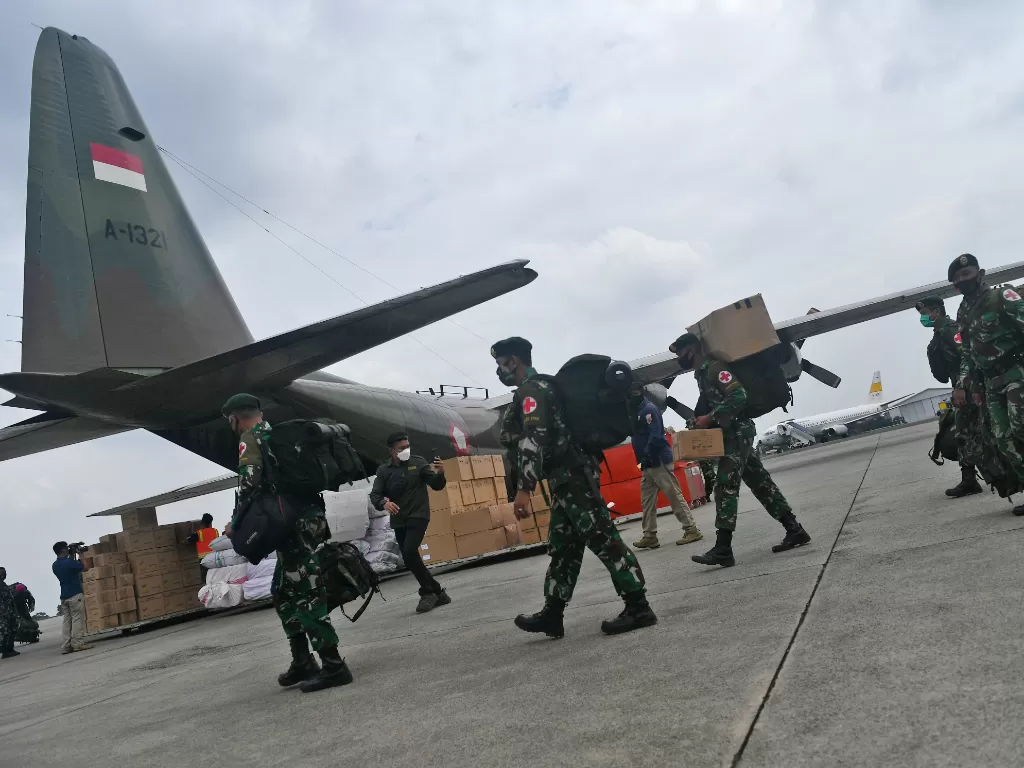 Prajurit TNI bersiap memasuki Pesawat Hercules A 1321 TNI AU yang membawa bantuan logistik untuk korban gempa bumi Majene di Lanud Halim Perdanakusuma, Jakarta, Jumat (15/1/2021). (photo/ANTARA FOTO/Sigid Kurniawan)