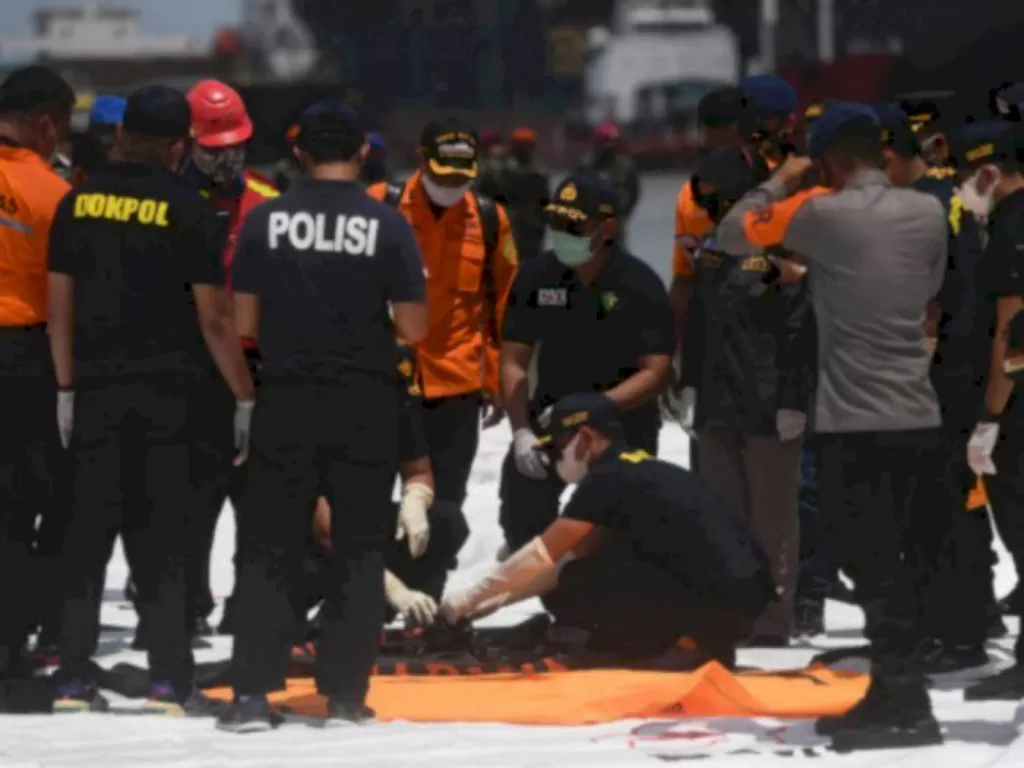 Petugas membawa jenazah berisi bagian tubuh korban pesawat Sriwijaya Air SJ182. (ANTARA FOTO/Akbar Nugroho Gumay)