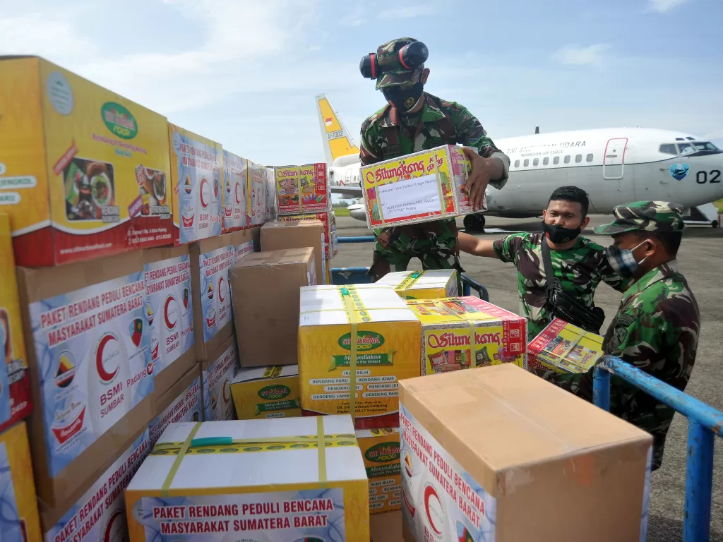 Personel TNI-AU Lanud Sutan Sjahrir, menyusun paket bantuan rendang untuk dikirim ke lokasi bencana, di Bandara Internasional Minangkabau (BIM), Padangpariaman, Sumatera Barat, Rabu (27/1/2021). (ANTARA FOTO/Iggoy el Fitra)