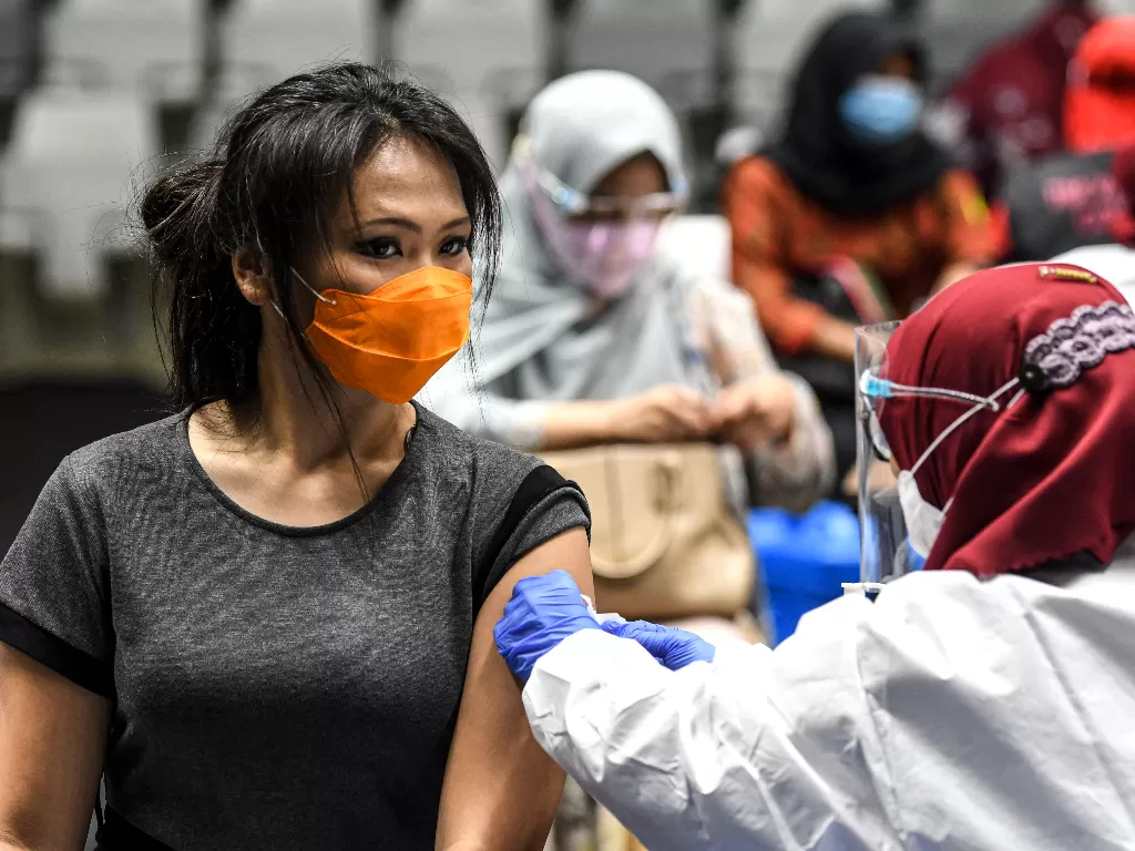Seorang petugas kesehatan mengikuti vaksinasi dosis pertama vaksin COVID-19 Sinovac di Istora Senayan, Jakarta, Kamis (4/2/2021).  (photo/ANTARA FOTO/M Risyal Hidayat)