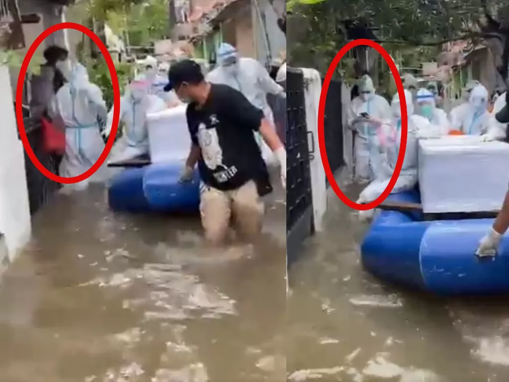 Cuplikan video tim pemulasaran jenazah Covid-19 Polda Metro Jaya saat evakuasi jenazah di tengah banjir. (Twitter @DivHumas_Polri)