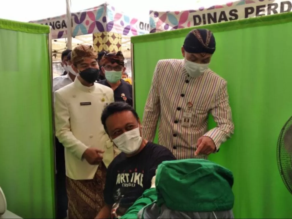  Gubernur Jawa Tengah Ganjar Pranowo dan Wali Kota Surakarta Gibran Rakabuming Raka saat meninjau vaksin di Pasar Klewer Solo. (ANTARA/Aris Wasita) 