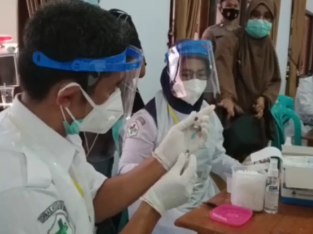 Seorang tenaga medis saat menyiapkan vaksin sebelum melakukan vaksinasi bagi tenaga petugas publik di Kota Baubau, Sulawesi Tenggara, Senin (15/3/2021). (ANTARA/Yusran)
