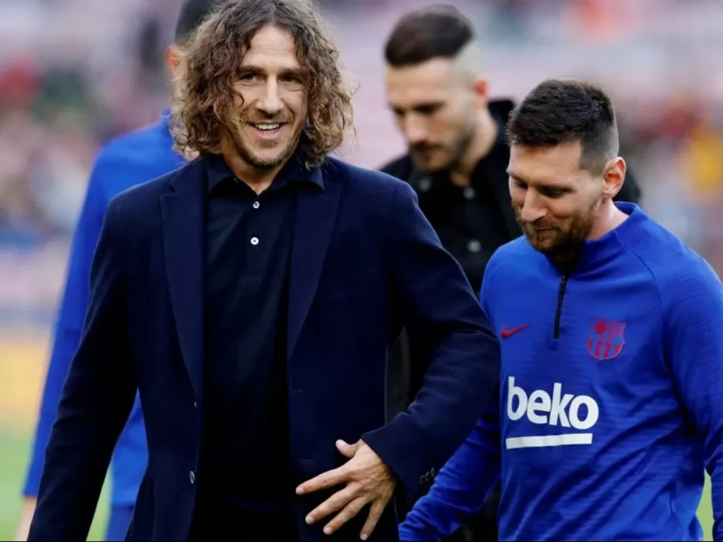 Carles Puyol dan Lionel Messi. (photo/REUTERS)