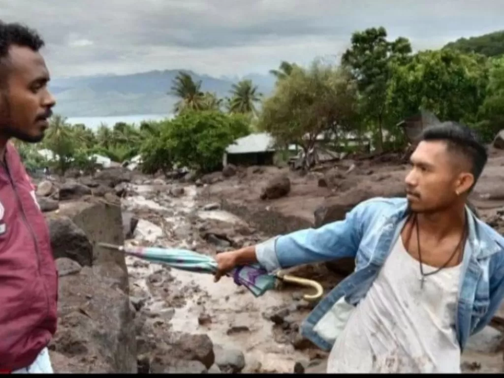Dua pemuda sedang membantu pencarian korban banjir dan longsir yang menerjang Desa Nele Lamadike, Kecamatan Ile Boleng, Kabupaten Flores Timur, Nusa Tenggara Timur (NTT) pada Minggu (4/4/2021). (FOTO: ANTARA/FB Kuma Nuba Tukan)
