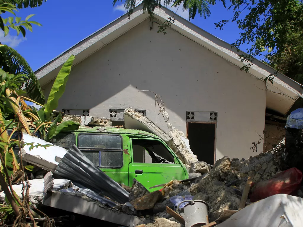 Satu unit kendaraan roda empat tertimpa tembok rumah yang hancur (ANTARA FOTO/Kornelis Kaha)