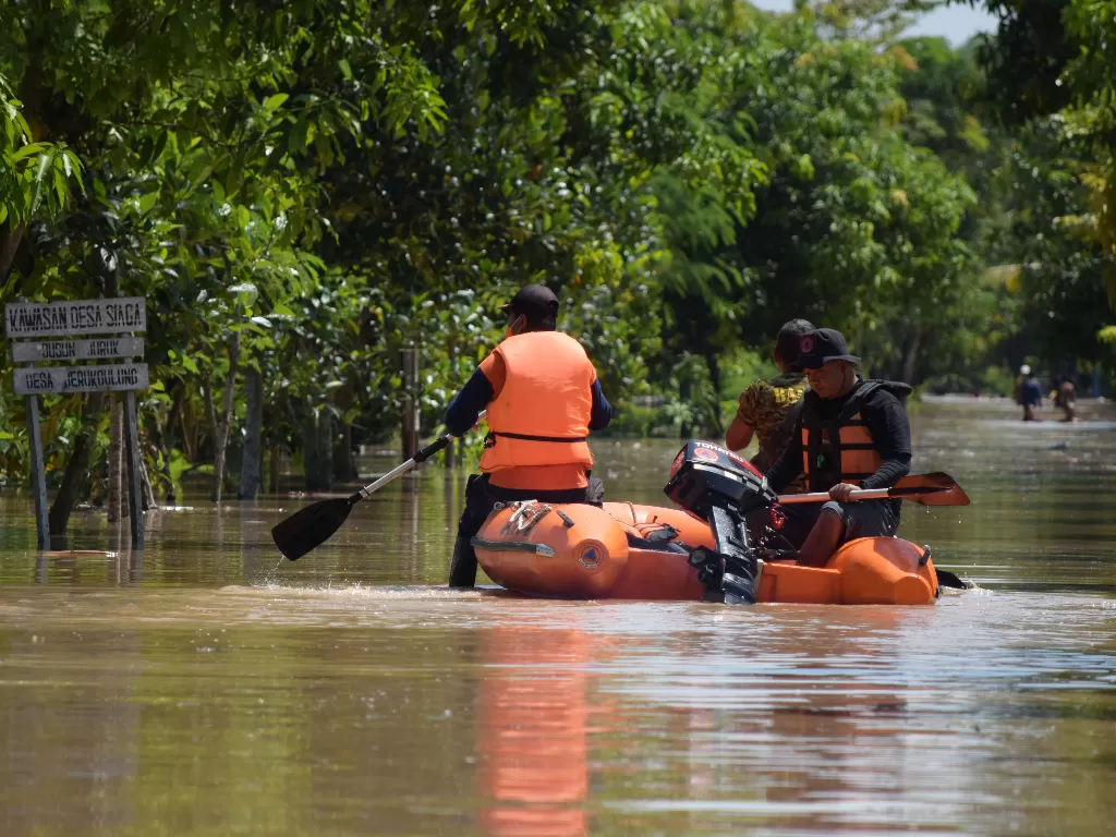 Petugas Badan Penanggulangan Bencana Daerah (BPBD) memantau kondisi banjir (ANTARA FOTO/Siswowidodo)