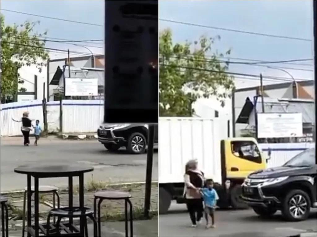 Ibu-ibu rela turun dari mobilnya demi bantu bocah menyeberang jalan (Instagram/makasar_info)